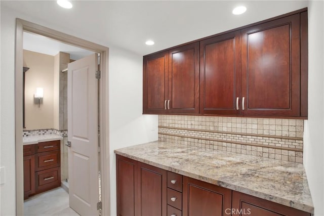 kitchen with tasteful backsplash and light stone countertops