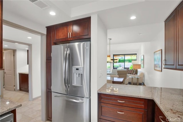 kitchen featuring light tile patterned flooring, pendant lighting, light stone counters, and stainless steel fridge with ice dispenser