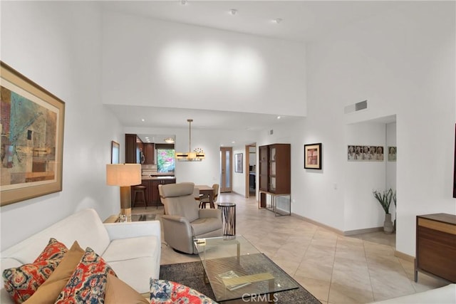 living room featuring light tile patterned floors and a high ceiling