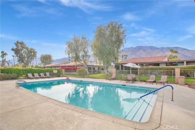 view of swimming pool featuring a mountain view and a patio