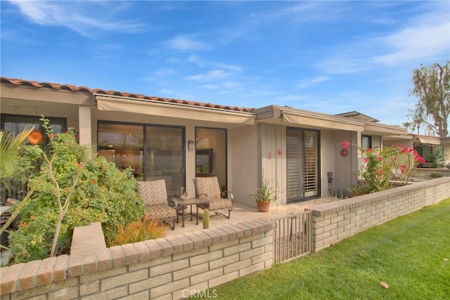 exterior space with a patio area and a front yard