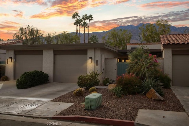 view of front of house with a garage and a mountain view