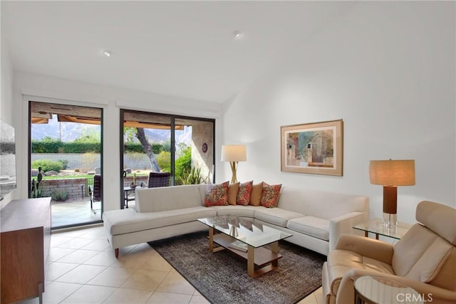 living room with vaulted ceiling and light tile patterned floors