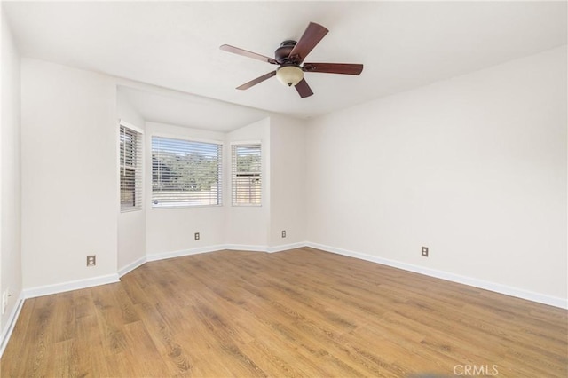 empty room with light hardwood / wood-style floors and ceiling fan