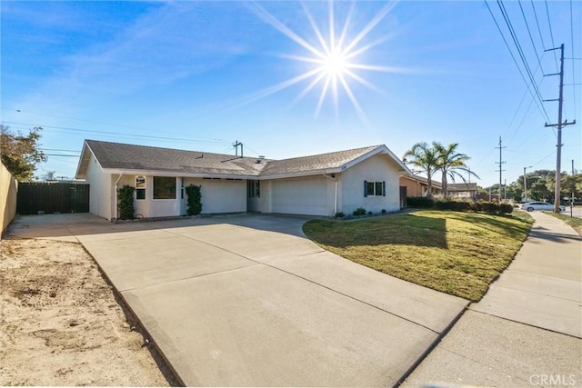 ranch-style house featuring a garage and a front lawn