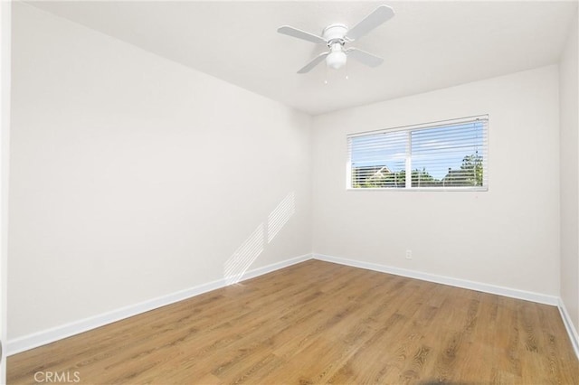 unfurnished room with hardwood / wood-style floors and ceiling fan