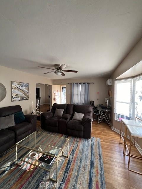 living room with ceiling fan and wood-type flooring