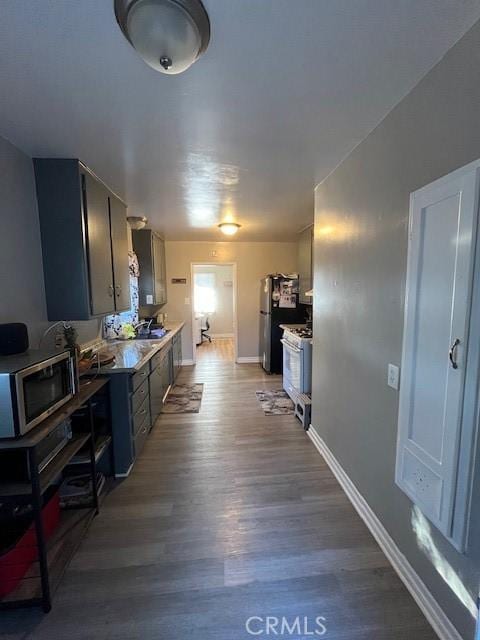 kitchen featuring stainless steel appliances and light hardwood / wood-style floors