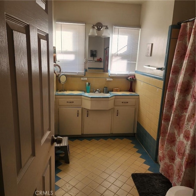 bathroom featuring tile walls, vanity, and tile patterned flooring