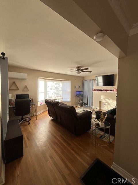 living room featuring ceiling fan, a wall mounted air conditioner, and hardwood / wood-style floors