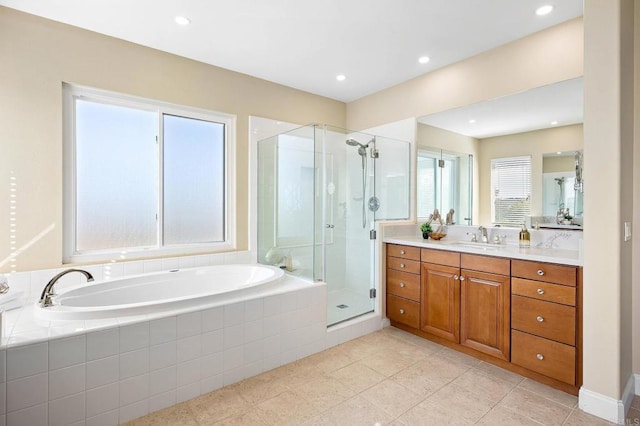 bathroom with tile patterned floors, vanity, and independent shower and bath