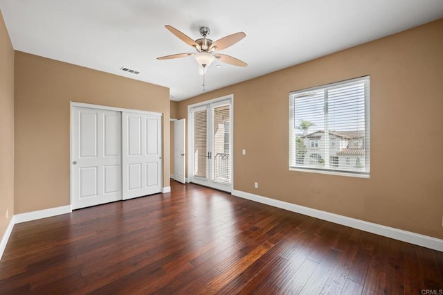 unfurnished bedroom with dark wood-type flooring and ceiling fan