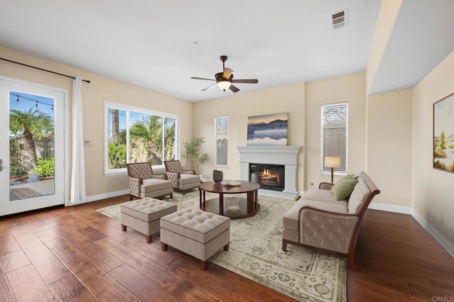 living room with ceiling fan and dark hardwood / wood-style floors