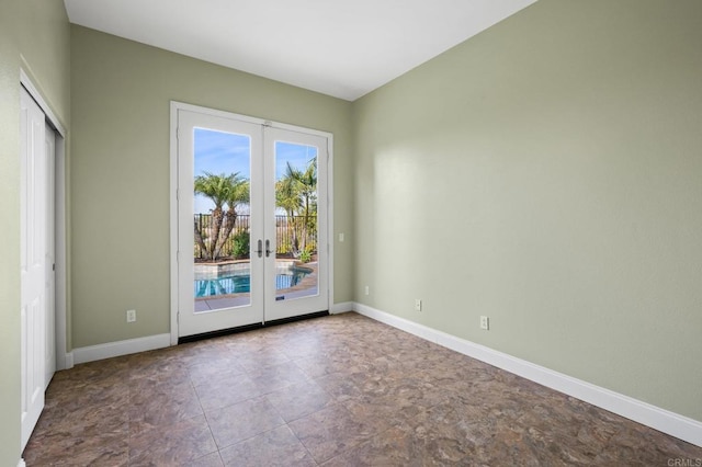 spare room featuring french doors