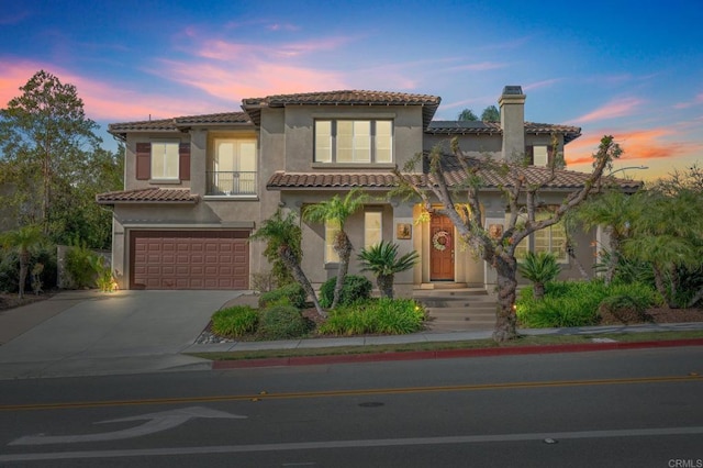 mediterranean / spanish home with a garage