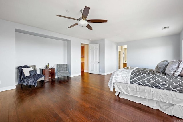 bedroom featuring ceiling fan, ensuite bathroom, and dark hardwood / wood-style floors