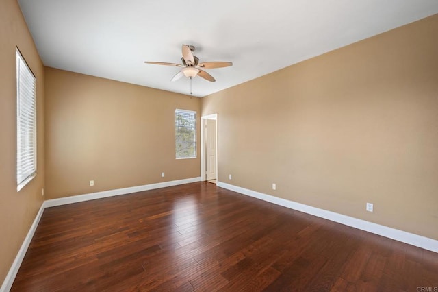 empty room featuring ceiling fan and dark hardwood / wood-style flooring