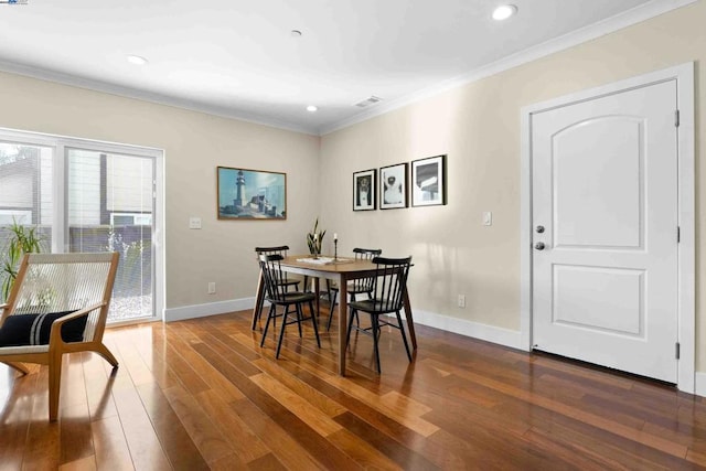 dining room featuring dark wood-type flooring and ornamental molding