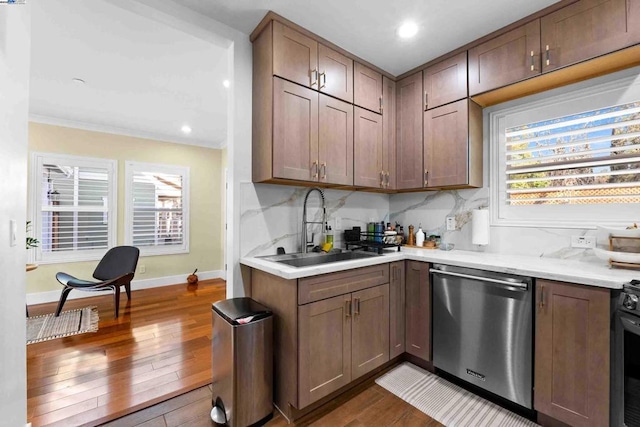 kitchen featuring dishwasher, sink, dark hardwood / wood-style flooring, and a healthy amount of sunlight