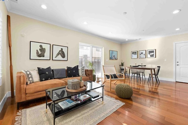 living room featuring wood-type flooring and ornamental molding