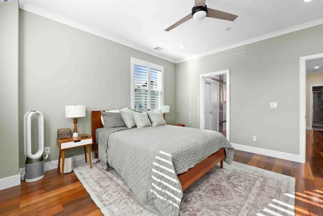 bedroom with crown molding, ceiling fan, ensuite bathroom, and hardwood / wood-style floors