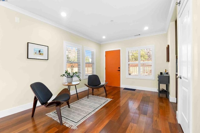 living area with a healthy amount of sunlight, ornamental molding, and dark hardwood / wood-style floors