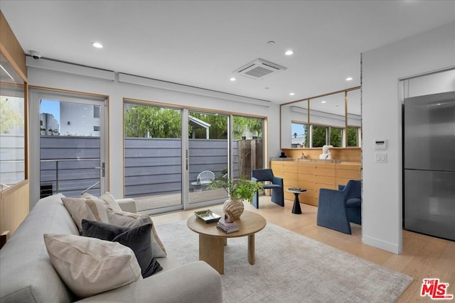 living room featuring light hardwood / wood-style floors and elevator