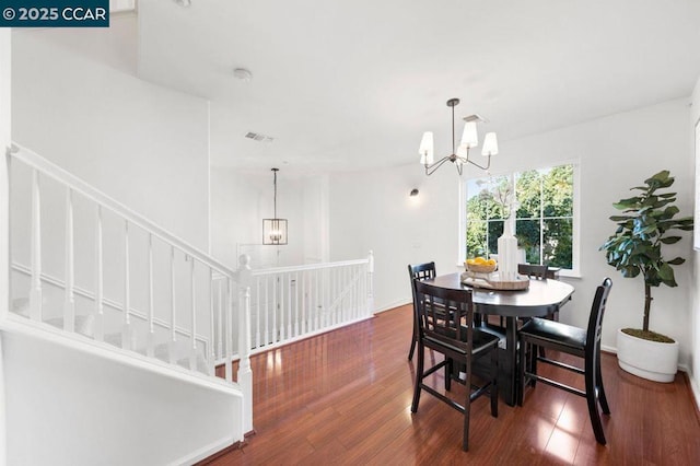 dining space featuring a chandelier and dark hardwood / wood-style floors