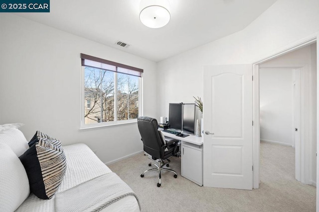 office space featuring light colored carpet and vaulted ceiling