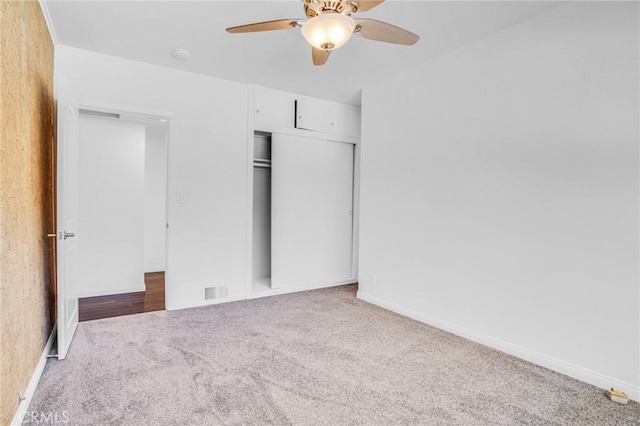 unfurnished bedroom with carpet flooring, a closet, and ceiling fan