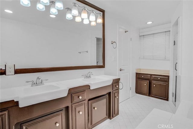 bathroom featuring a shower with door, vanity, and tile patterned flooring