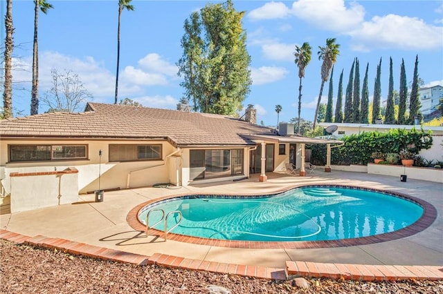 view of pool with a patio area and central air condition unit