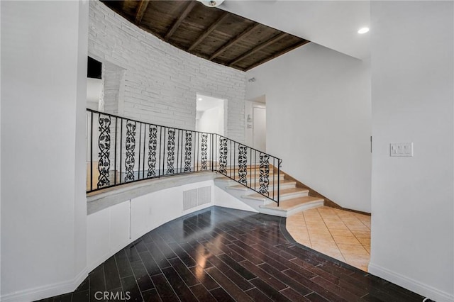 stairway with wood ceiling