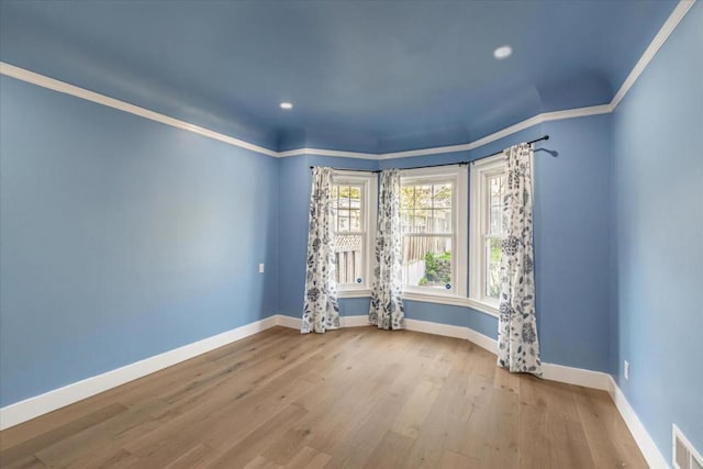 empty room with light hardwood / wood-style flooring