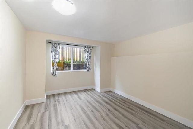 unfurnished room with light wood-type flooring