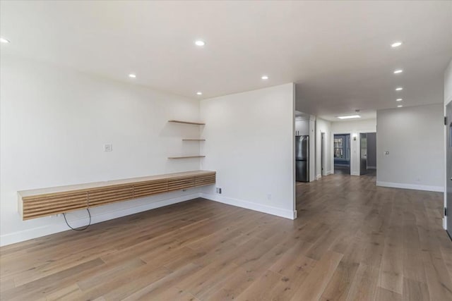 spare room with hardwood / wood-style floors