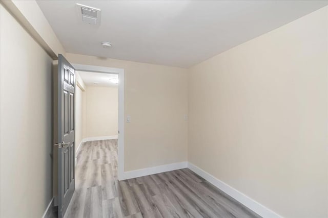 unfurnished room with light wood-type flooring