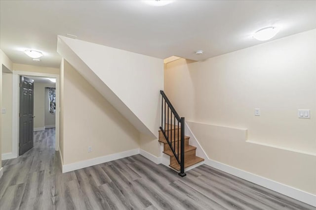 stairs featuring hardwood / wood-style floors