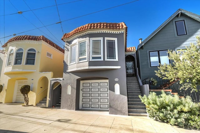 mediterranean / spanish-style home with a garage