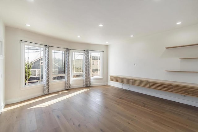 unfurnished room with hardwood / wood-style floors