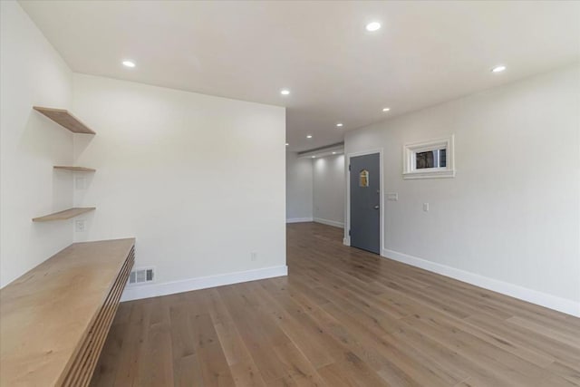 unfurnished room featuring dark wood-type flooring