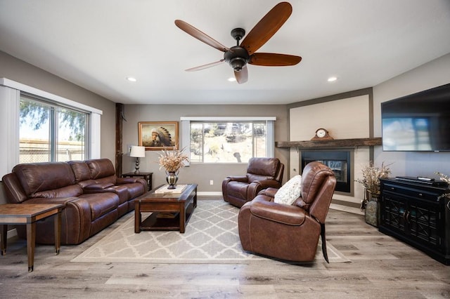 living room with ceiling fan and light wood-type flooring