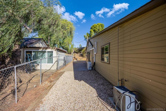 view of home's exterior with ac unit and a patio