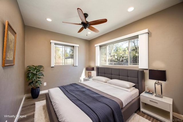 bedroom with ceiling fan and hardwood / wood-style flooring