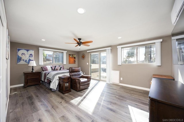 bedroom featuring hardwood / wood-style flooring, access to exterior, and ceiling fan