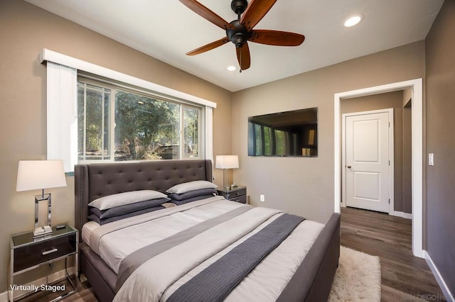 bedroom featuring ceiling fan and dark hardwood / wood-style flooring