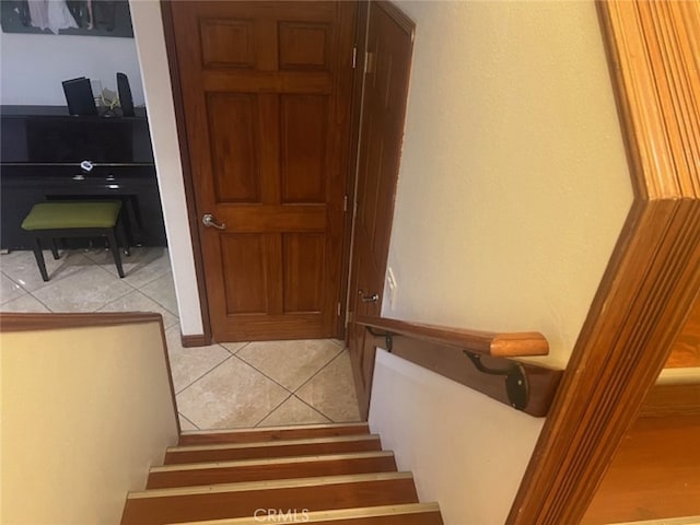 staircase featuring tile patterned flooring