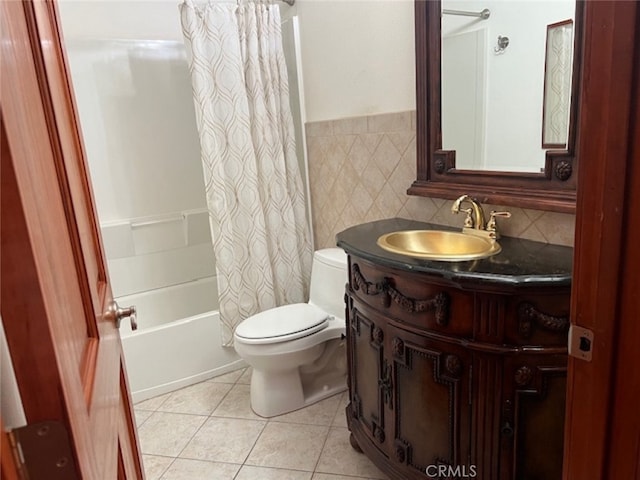 full bathroom featuring tile patterned floors, toilet, tile walls, vanity, and shower / bath combo