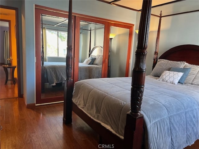 bedroom with dark hardwood / wood-style floors