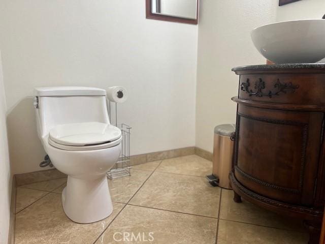 bathroom featuring vanity, tile patterned floors, and toilet